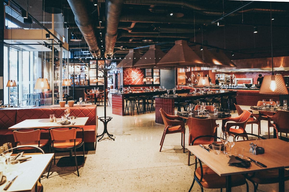 Warm, full dining room of a busy restaurant