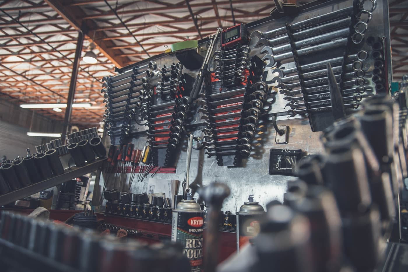 Mechanic working under a car on a lift in an auto repair shop