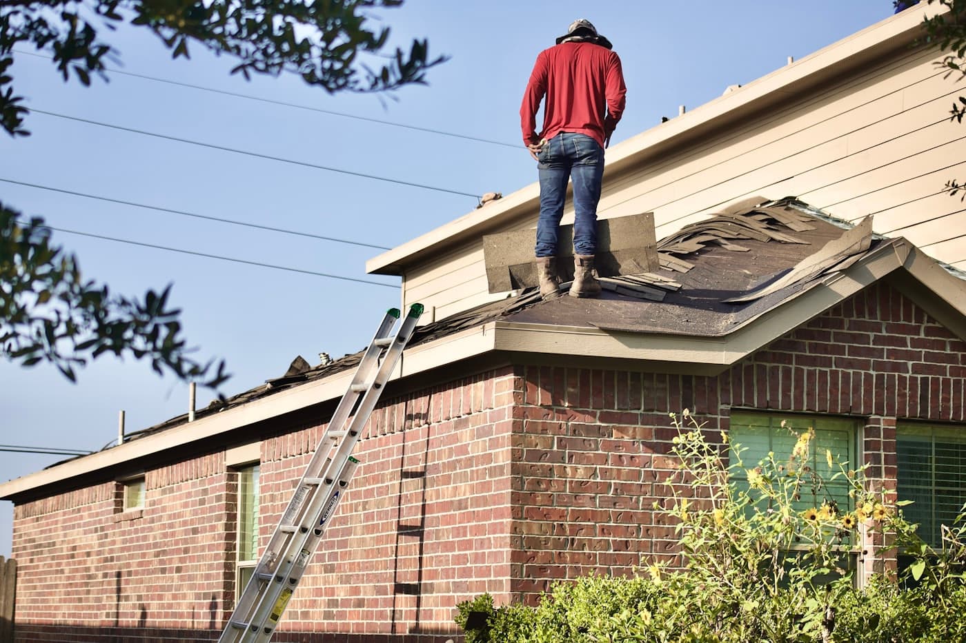 Roofing crew installing shingles on a residential roof