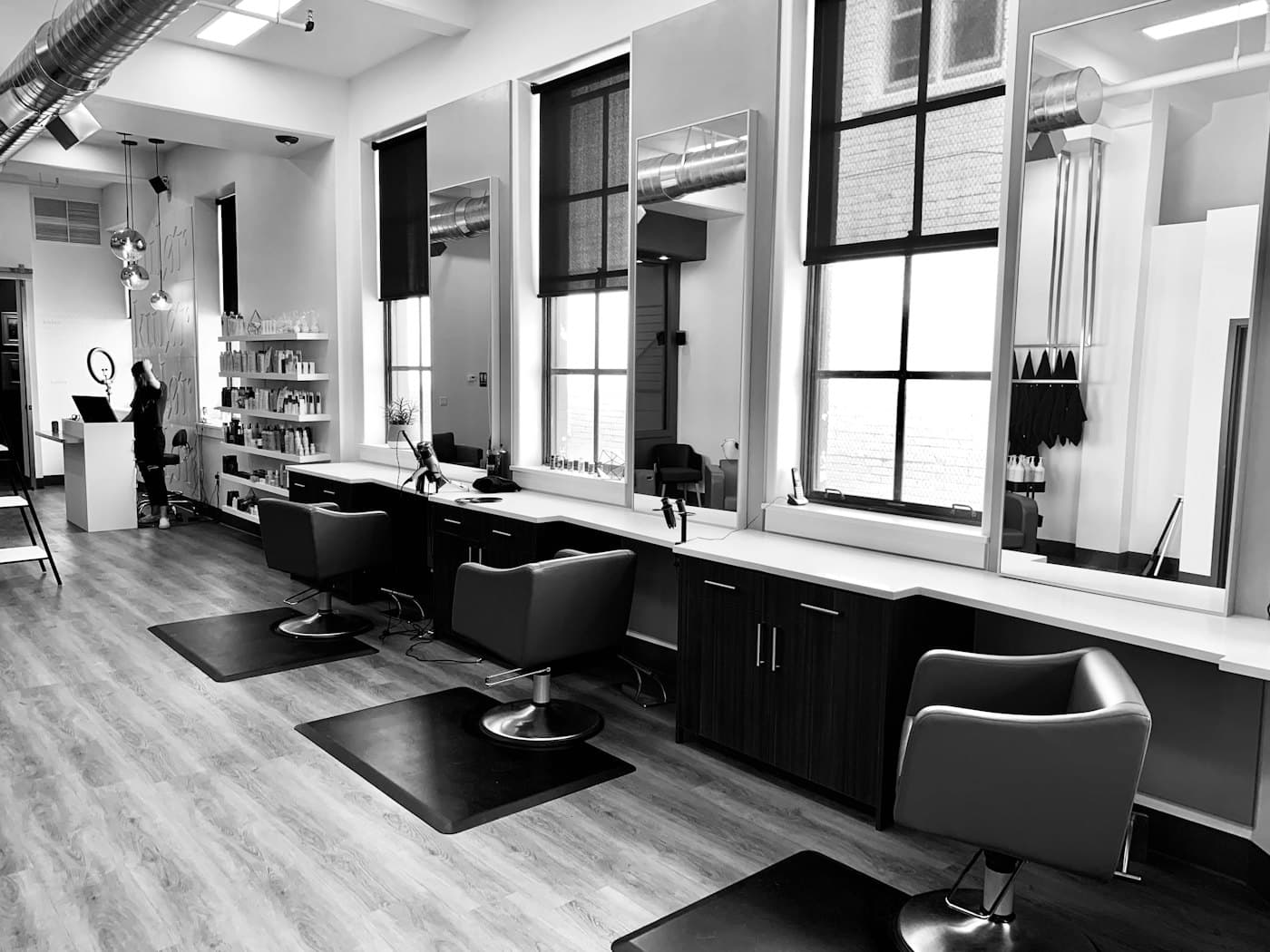 Stylist working with a client inside a modern hair salon